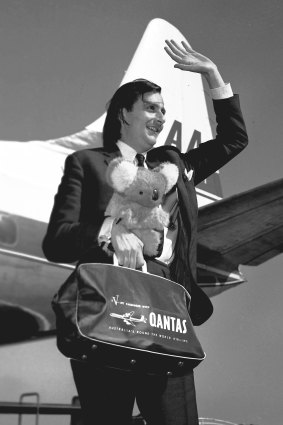 Barry Humphries with koala and Qantas bag arrives in Melbourne in 1965.