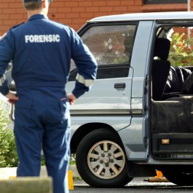 Police examine the van in which Jason Moran and Pasquale Barbaro were murdered.