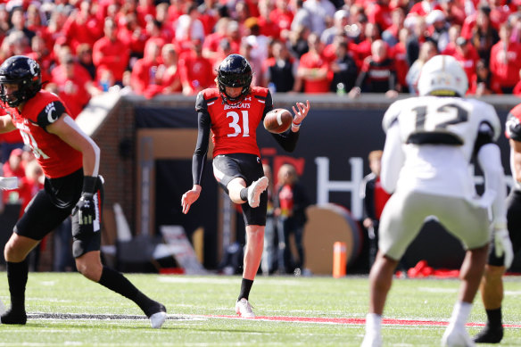 Mason Fletcher punts for the Cincinnati Bearcats during a college football match this season against the UCF Knights.