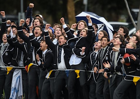 Caulfield Grammar students cheer a goal. Private school graduates are four times more likely to be drafted to the AFL than public school students.