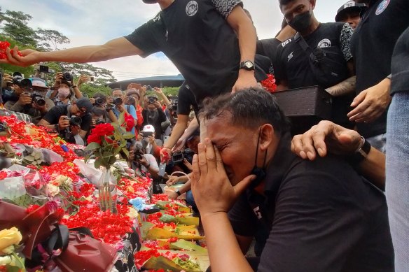 Arema assistant coach Kuncoro prays outside the stadium on Monday.