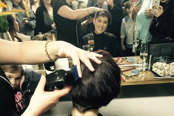 Ashlee Williams having her hair shaved off. 