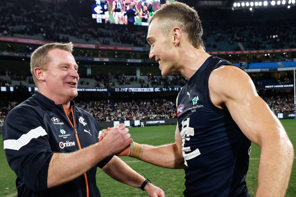 Patrick Cripps celebrates with Michael Voss.