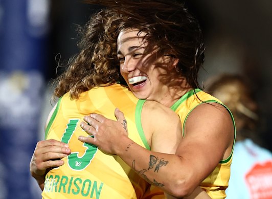 Chloe Molloy, right, celebrates a goal with Australian teammate Nina Morrison.