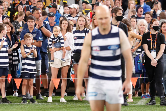 Gary Ablett jnr walks to his guard of honour in his last game, with wife Jordan and son Levi looking on.