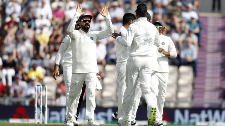 Got 'im: India's Virat Kohli (left) celebrates with teammates after Alastair Cook's dismissal.