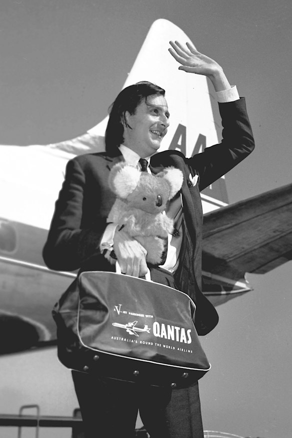 Barry Humphries with koala and Qantas bag arrives in Melbourne in 1965.