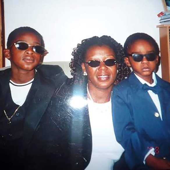 Young Kofi (right) with his brother Kojo and mother Doris.