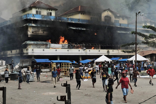 A market burns during a protest in Fakfak, Papua, on August 21.