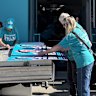 Monique Ryan’s campaign staff and volunteers prepare pre-poll and election-day material. 