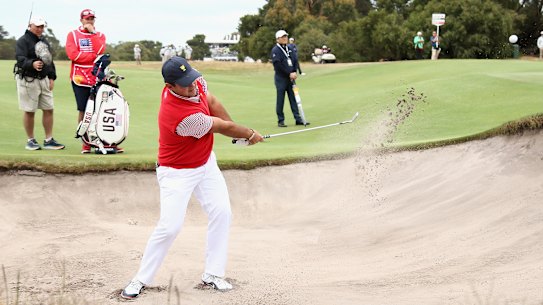 'Captain America' Patrick Reed plays out of the bunker on day one in Melbourne.