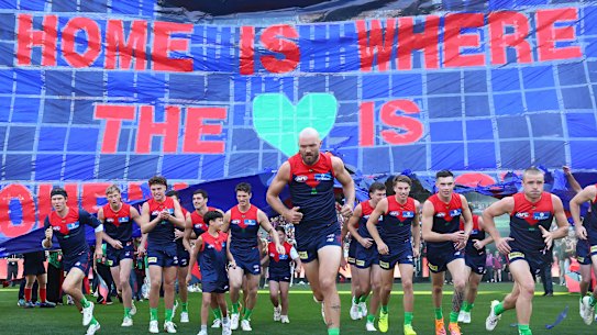 Melbourne captain Max Gawn leads the Demons on the field at the MCG. 