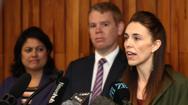 NZ Prime Minister Jacinda Ardern, right, and Minister for COVID-19 Response Chris Hipkins, centre, speak to media at Auckland University on December 17.
