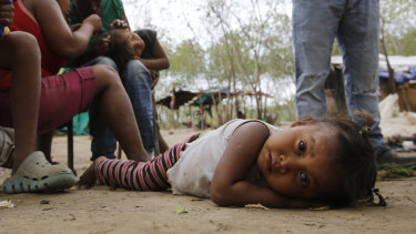 Along the banks of the Tachira River dividing Colombia and Venezuela, many of the indigenous children have distended bellies from malnutrition or parasites.