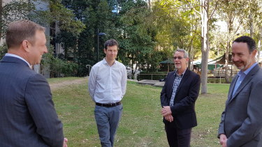 Deputy Premier and Health Minister Steven Miles (left) speaks to UQ vaccine project leads Associate Professor Keith Chappell, Professor Paul Young and Professor Trent Munro on Thursday.
