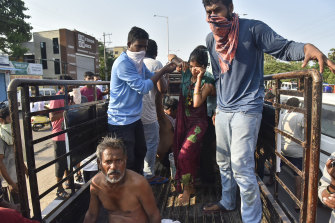 People affected by the gas leak are carried out of a truck to an ambulance.