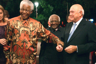 Tutu, centre, with Mandela and former president FW de Klerk at de Klerk’s 70th birthday party in Cape Town in 2006.
