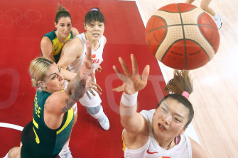 Chinaâ€™s Meng drives to the basket against Cayla George.