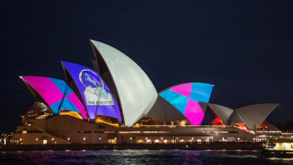 Protestors shine light onto the sails of the Opera House during the launch of the Everest barrier draw projection.