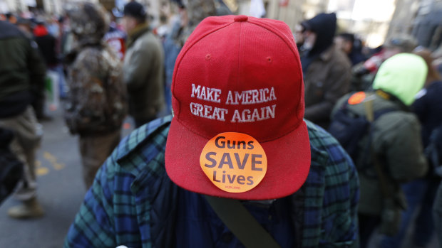 A man walks in the crowd during a pro-gun rally in Richmond, Virginia. 