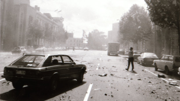 A police officer on the street in the immediate aftermath of the explosion outside of the Russell Steet Police Station in March 1986. 