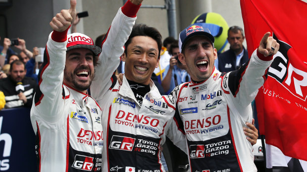 Toyota TS050 Hybrid No.8 drivers Fernando Alonso, Kazuki Nakajima and Sebastien Buemi celebrate after winning the 86th Le Mans 24 Hours endurance race on Sunday.