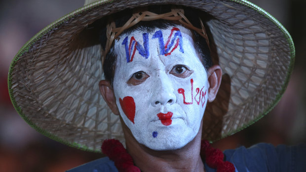 A supporter of Pheu Thai Party wears a message on his head reading "Pheu Thai Party love people" during an election campaign in Bangkok on Friday.