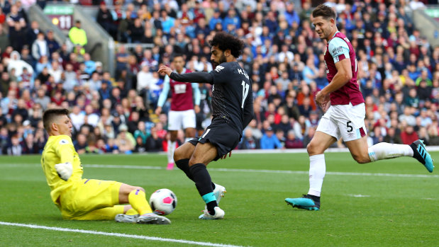 Blocked: Mohamed Salah zeroes in on goal at Turf Moor.