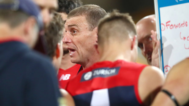 Melbourne coach Simon Goodwin addresses his players during the match against Port Adelaide.