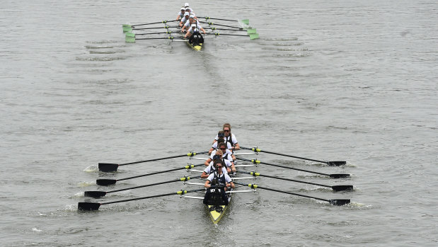 Cambridge, top, lead Oxford down the Thames during the women's boat race on Sunday.