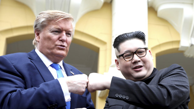 U.S. President Donald Trump impersonator Russell White, left, and Kim Jong-un impersonator Howard X pose for photos outside the Opera House in Hanoi, Vietnam.