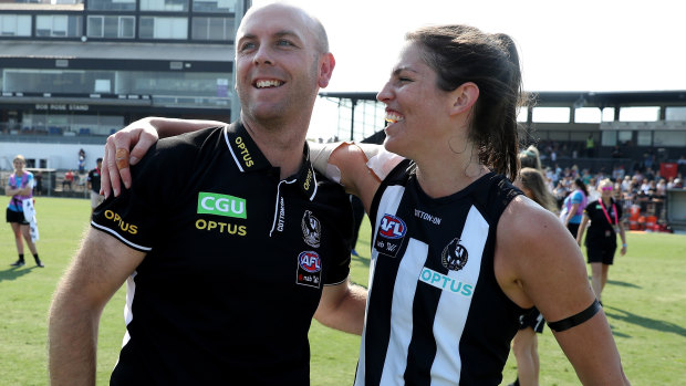 Off the mark: Coach Wayne Siekman celebrates a first AFLW win with Eliza Hynes, after the Magpies saw off the Lions at Victoria Park in Melbourne.
