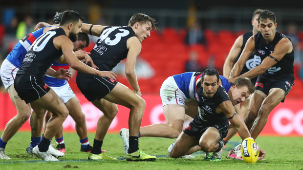 In the thick of it: Carlton forward Eddie Betts scrambles to clear the ball from the pack during their round 6 clash against the Western Bulldogs at Metricon Stadium on the Gold Coast.