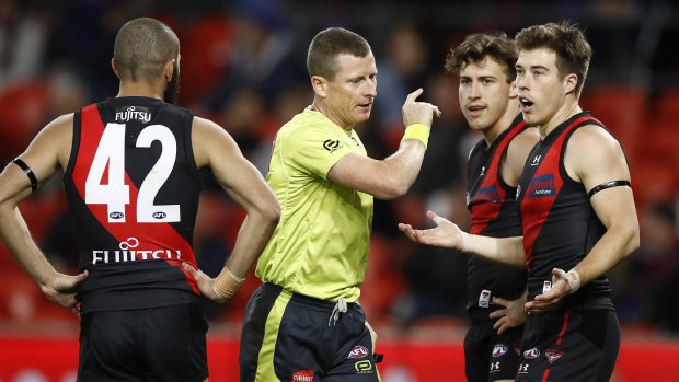 Lost in translation: Essendon's Zach Merrett (right) appeals to the umpire after the controversial call made during their round 9 match against the Lions.