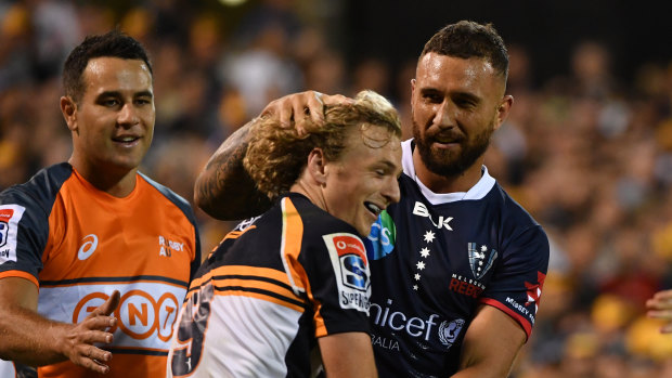 Niggle and giggle: Quade Cooper lets Joe Powell know he's back in Super Rugby.