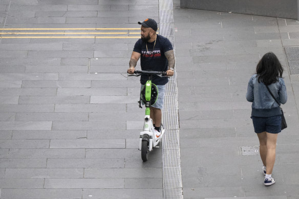 E-scooter riders on the footpath on Southbank Boulevard.