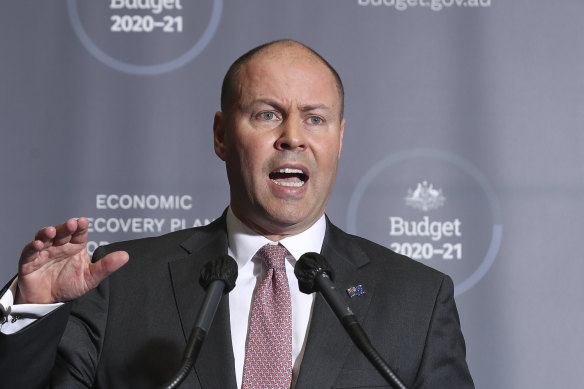 Treasurer Josh Frydenberg addresses the media on the release of the 2020-21 budget. Economists say there may be a trade off between tighter fiscal and monetary policy.