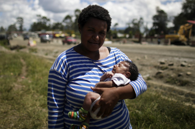 Ruth Ismile with her son, Carlvert, after he received his tetanus vaccination  at a mobile clinic.