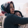 Women embrace as rescue workers search through the rubble in Adiyaman, Turkey, on February 8.