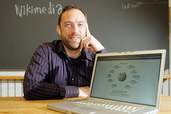 Jimmy Wales in 2006 with an early iteration of Wikipedia.