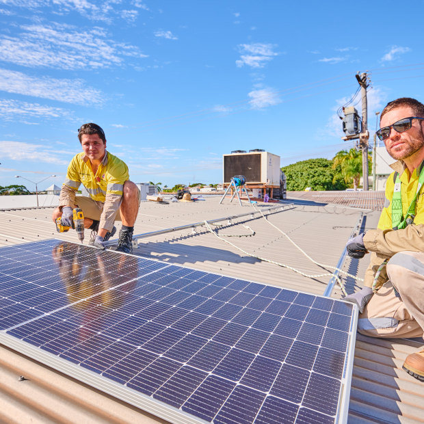 Gas plant electricians Ciaran Fallon and Tom Willis at their side project installing rooftop solar. 