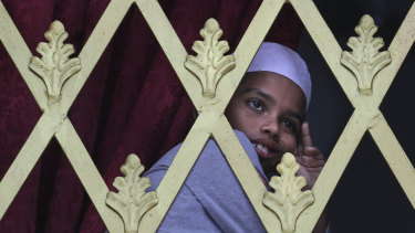 A Sri Lankan Muslim boy looks out from the window of a Mosque before Friday prayers in Colombo.