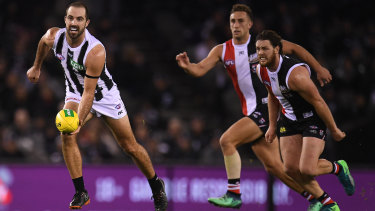 Field day: Magpie Steele Sidebottom gets away cleanly from his Saints opponents.