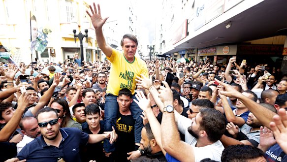 Jair Bolsonaro is taken on the shoulders of a supporter moments before being stabbed during a campaign rally in Juiz de Fora, Brazil.