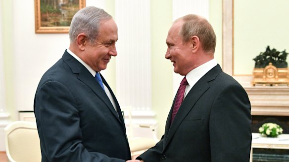 Russian President Vladimir Putin, right, shakes hands with Israeli Prime Minister Benjamin Netanyahu during their meeting at the Kremlin in Moscow on July 11.