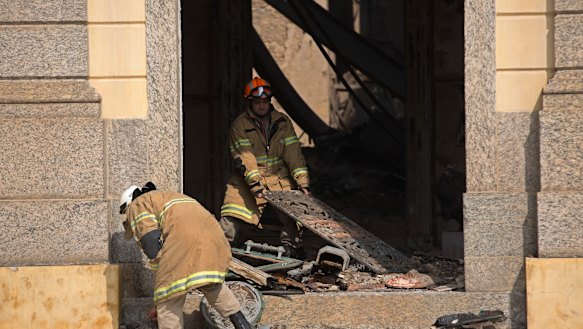 Firefighters removed remnants of artifacts and paintings that survived the fire.