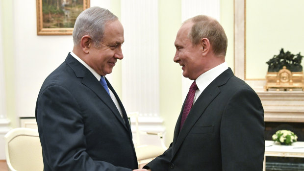 Russian President Vladimir Putin, right, shakes hands with Israeli Prime Minister Benjamin Netanyahu during their meeting at the Kremlin in Moscow on July 11.