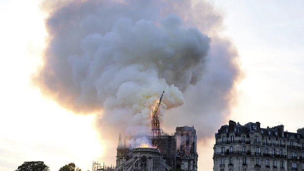 Flames and smoke rise as the spire on Notre-Dame Cathedral collapses.