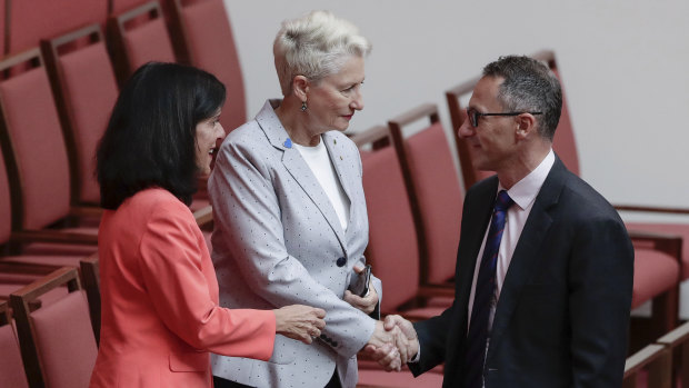 Julia Banks and Kerryn Phelps shake hands with Richard Di Natale after the bill passed the Senate on Wednesday.