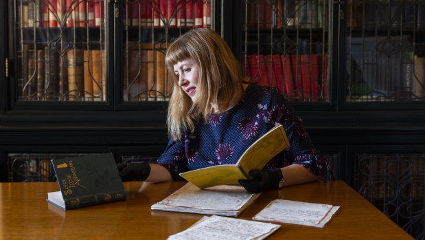 State Library of NSW curator Sarah Morley with the original manuscript of Ethel Turner's Seven Little Australians. It has been included in the Unesco Australian register of the memory of the world. 